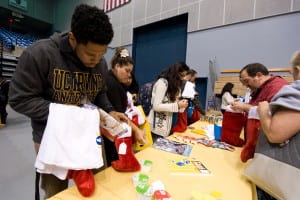 Anthony Poullard, a graduate student in education, stuffs stockings after the Fifty for 50 spirit rally for children served through the Olive Crest organization. Steve Zylius / UC Irvine 