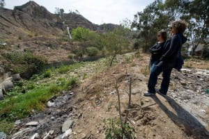 Reyes (right) and UCI doctoral student Kristen Goodrich examine a severely eroded and flood-damaged canyon area in Tijuana, Mexico, as part of the FloodRISE project. Steve Zylius / UC Irvine